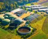 Planta de biogás con biodigestores y granjas. Las desventajas de la biomasa incluyen el uso de grandes extensiones de tierra y la necesidad de infraestructura.