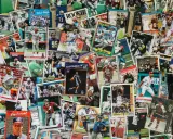 A colorful collage of sports trading cards, showcasing baseball, basketball, and football players. This collection could be part of an art consignment, where unique items are displayed and sold.