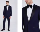 A man models a navy tuxedo with black satin lapels. Inquire about how much are tuxedos rentals for your next formal event.