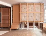 Progetto di ristrutturare casa con 10.000 euro: struttura in legno grezzo, pannelli isolanti e arredi modulari in cartone.