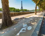 Radweg am Seine-Ufer mit Blick auf den Eiffelturm. Ein Zeichen für die moderne Stadtentwicklung in Paris, die auf nachhaltige Mobilität setzt.