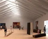 Besökare njuter av konst i en ljus konsthall i Tornedalen. Träskulpturer och målningar visas upp.