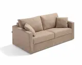 En beige soffa med lösa kuddar, perfekt för den som vill byta stoppning soffa och ge den nytt liv.