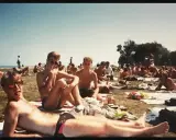 A group of men relax on the grass at a gay beach in Chicago.