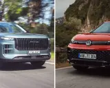 Dwa SUV-y na drodze: szary z pionową atrapą i czerwony Volkswagen SUV z charakterystycznym logo.