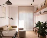 Salón moderno con sofá beige, mesa y dos pufs. Las paredes lucen un impecable **microcemento acabado**, aportando elegancia y minimalismo.