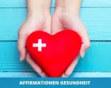 Hände halten ein rotes Herz mit einem weißen Kreuz. Es symbolisiert positive Affirmationen für Gesundheit und Wohlbefinden.