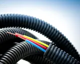 Trois câbles colorés sortent d'une gaine ondulée noire. La question est : combien de cable dans une gaine ?