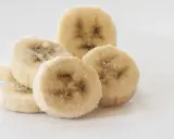 Ein Haufen gefrorener Bananenscheiben, bereit zum Einfrieren für Smoothies oder Desserts.