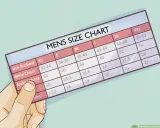 A hand holds a men's size chart, showing measurements for body chest and jacket chest, with a column for overarm measurement.