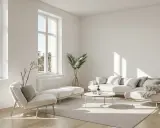 Un salon lumineux et aéré, typique d'un appartement traversant, avec un canapé modulable, un fauteuil, une table basse et des plantes vertes.
