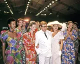Models and designer Yves Saint Laurent at the Staley Wise Gallery fashion show, showcasing vibrant, patterned dresses and bold accessories.