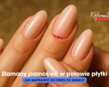 Złamany paznokieć w połowie płytki, z widocznym pęknięciem. Dłoń z zadbanymi paznokciami na złotym tle.