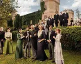 Un gruppo di persone in abiti d'epoca posa davanti a un castello. Un riassunto de "La Promessa" con i suoi personaggi principali.