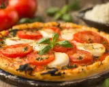 Délicieuse tarte tomate mozza, garnie de basilic frais et de tomates juteuses, prête à être dégustée sur un fond rustique.