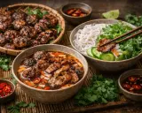 En härlig buffé med vietnamesisk mat: grillade köttbullar, nudlar med grönsaker och en smakrik buljong.
