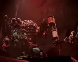 Makabryczny prototyp Poppy Playtime: szkielety i potargane zabawki wiszą na metalowej konstrukcji w mrocznym, czerwonym świetle.
