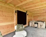 Un'accogliente dependance in legno con tavolo e sedute, perfetta per idee di relax all'aperto.
