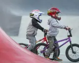 Dwóch chłopców w kaskach na rowerach BMX gotowych do zjazdu. Idealne rzeszów atrakcje dla dzieci do aktywnego spędzania czasu.