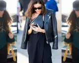 Donna con giacca in pelle, cappello e borsa a tracolla, look casual chic.