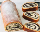 Stary przepis babci na makowiec. Puszysty, pachnący makowiec z cukrem pudrem, pokrojony na plastry, odsłaniający bogate nadzienie makowe.