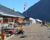Górskie schronisko, idealne na przerwę podczas tour de Mont Blanc. Dwa rowery, szwajcarskie flagi i piękne widoki.