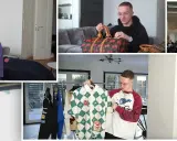 Mann mit Brille präsentiert seine Justin Modemarke Kollektion, darunter Hoodies, Hemden und eine Tasche mit Kirschen.