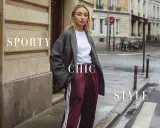Modella con blazer oversize e pantaloni sportivi bordeaux, un perfetto esempio di stile sportivo chic in città.