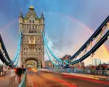 Tower Bridge in London, a city renowned for its art, glows under a double rainbow at dusk.