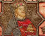 Ein König mit Krone und Bart, der ein Schwert und ein Gebäude hält, umgeben von Ornamenten. Möglicherweise eine Darstellung aus dem Jahr 800 nach Christus.