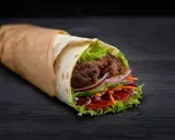 Kebab zawinięty w placek z mięsem, sałatą, pomidorem, ogórkiem i cebulą.