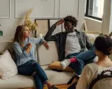 Pareja discutiendo en terapia, buscando soluciones a su **crisis de pareja**. La mujer gesticula, el hombre escucha con la mano en la cabeza.