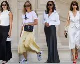 Four women in stylish outfits featuring satin skirts in black, yellow, and white.
