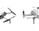 Porównanie dronów DJI: dwa białe modele Mini 3 Pro i Mini 2 SE z rozłożonymi śmigłami na białym tle.