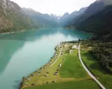 Vacker vy över en sjö med berg och campingplatser i Norge. Perfekt för dig som söker campingplatser Norge.