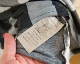 Metka z napisem Burberry, Made in Portugal. Sprawdź metkę, by dowiedzieć się, jak rozpoznać oryginał.