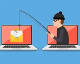 Ein Hacker versucht mit einer Angel, Zugangsdaten von einem Laptop zu stehlen. Ein Symbol für online betrug.