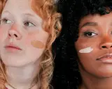 Dos mujeres, una pelirroja pecosa y otra de piel oscura, muestran diferentes tonos de piel con muestras de maquillaje.