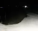Nocne widoki z olczański wierch kamery. Ośnieżony stok i wyciąg narciarski w ciemności.