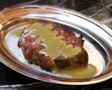 Tranché de bœuf, nappé d'une sauce verte, une spécialité parisienne servie sur un plateau métallique.