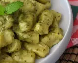 En skål med krämig italiensk gnocchi med pesto, toppad med färsk mynta. Ett perfekt italiensk gnocchi recept för en snabb och god middag.