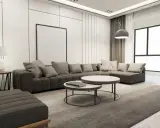 Nowoczesny salon z szarą sofą, dwoma stolikami kawowymi i dywanem. Wnętrze emanuje **quiet luxury**, gdzie każdy element jest dopracowany w subtelny sposób.