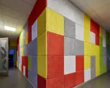 Kolorowa ściana z płyt z wełny drzewnej w korytarzu.
