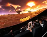 Besökare njuter av en dinosaurieupplevelse i en kupolformad salong, som en del av universum i Göteborg.