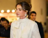 Queen Rania's elegant style shines in a cream, floral-patterned blouse with a chic pussy-bow.