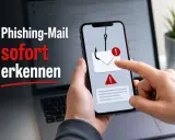 Smartphone zeigt eine Phishing-Mail mit Haken und Warnsymbolen. So erkennst du den Unterschied zwischen Spam und Phishing.