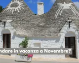 Trulli pugliesi con simboli bianchi sui tetti conici. Scopri cosa fare a novembre in Italia, tra borghi e sapori autunnali.