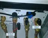 Detalle de conexiones de caldera. Flecha roja señala "Vaciado de la caldera" y otra flecha roja indica "Llave de Llenado".