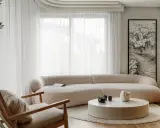 Jasny salon z puszystą kanapą i fotelem. Inspirujące pomysły na pokój z grafiką fal i okrągłym stolikiem.