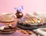 Czekoladowy tort i pralinki na talerzyku, kawa i kwiaty. Idealny przepis na zdrowe słodycze.